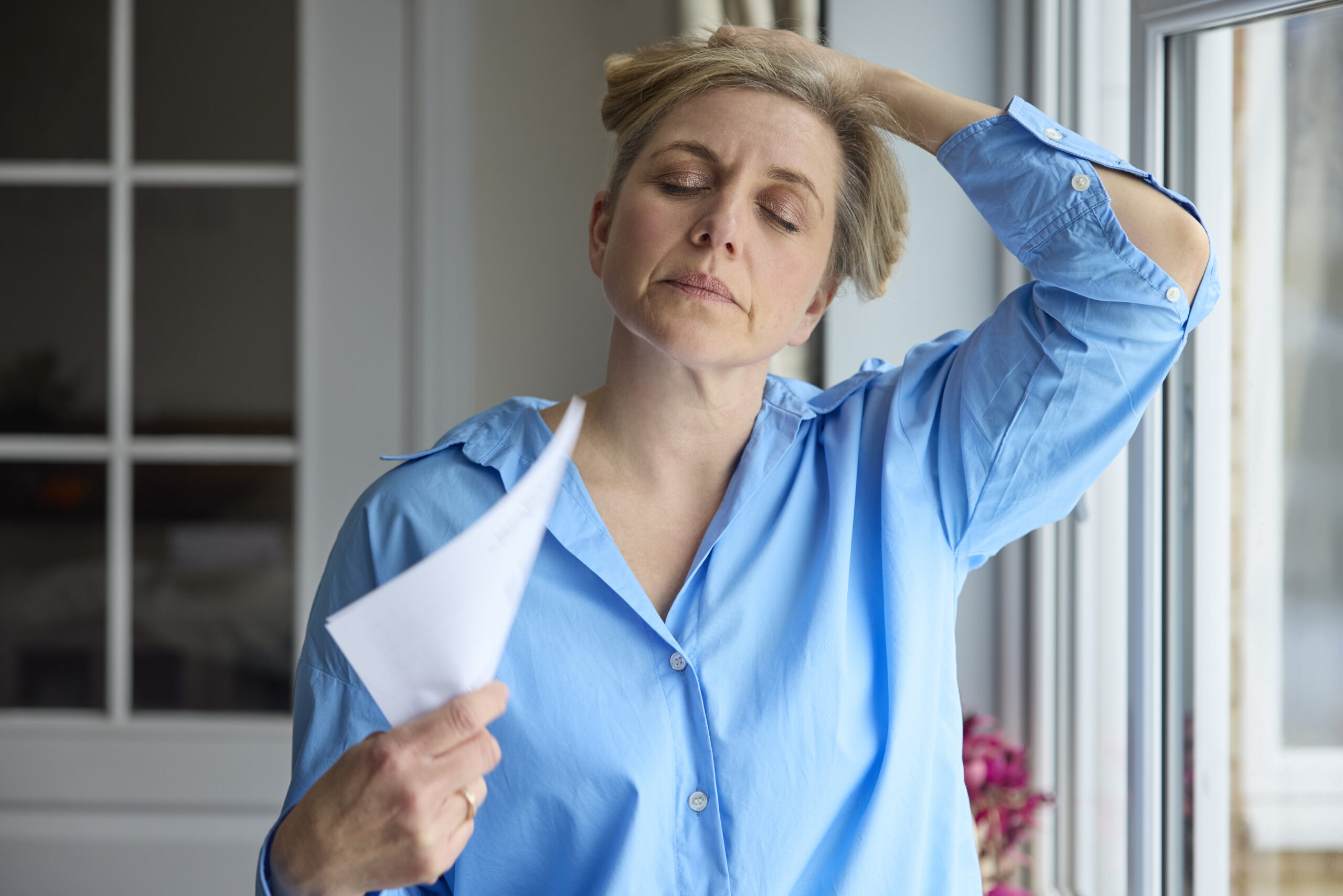 Women having a hot flush at home