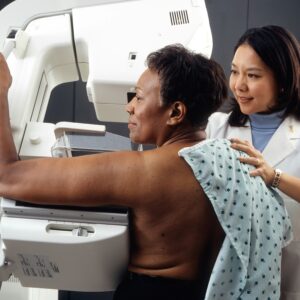 Women in a mammogram machine